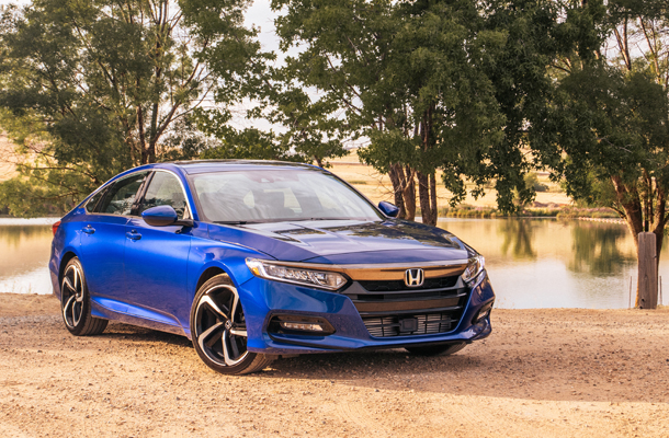 A beautiful blue honda parked in front of a setting sun shows the high quality work that Coach Works Collision Center performs.